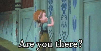 a little girl is standing in front of a wall and asking are you there .