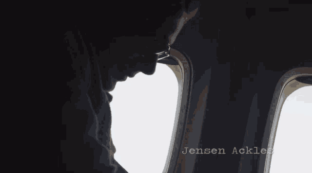 a silhouette of a person looking out of an airplane window with jensen ackles written below them