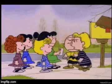 a group of peanuts characters standing next to each other on a sidewalk