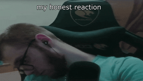 a man wearing glasses and headphones is laying in a gaming chair with the words " my honest reaction " written on it