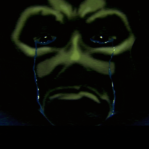 a close up of a person 's face with tears running down their face