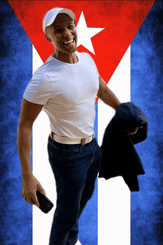 a man standing in front of a cuban flag holding a jacket