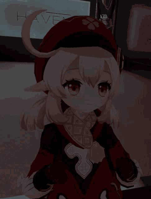 a little girl with a red hat is sitting in front of a haven sign