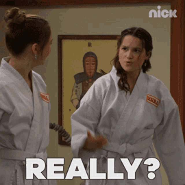 two women in karate uniforms are standing next to each other and one of them is asking the other " really "