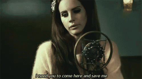 a woman is singing into a microphone with the words " i need you to come here and save me " below her