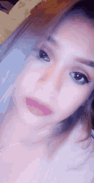 a close up of a woman 's face with her eyes closed