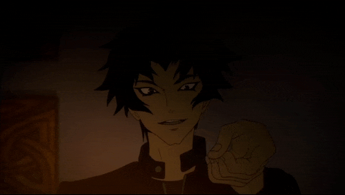 a man with vampire teeth is making a face in the dark