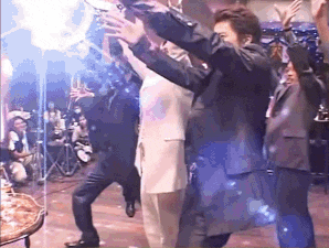 a group of people are dancing together on a stage .