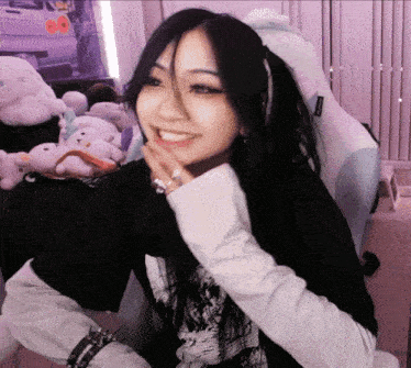 a woman wearing a black shirt and white sleeves smiles for the camera