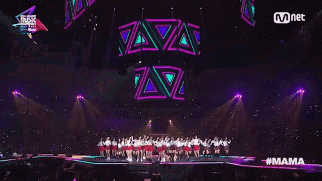 a group of women are dancing on a stage with the hashtag mama