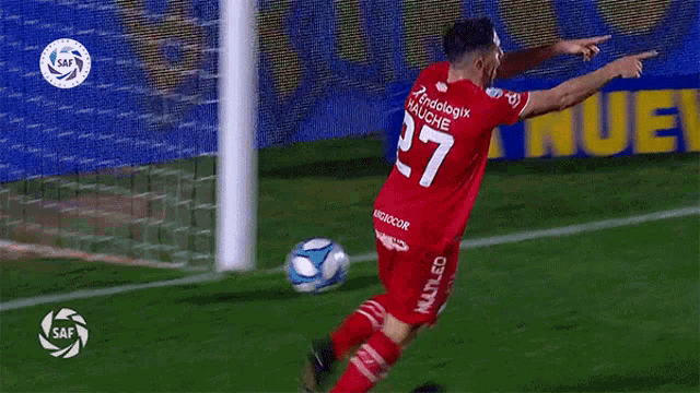 a soccer player wearing a red jersey with the number 7 on it