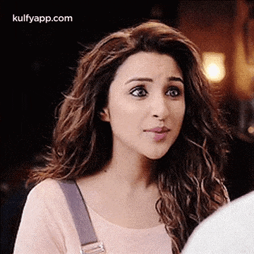 a woman with long hair is making a funny face while looking at a man .