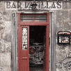 a red door is open to a store with the word bar on the top of it .