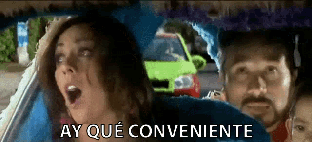 a woman is sitting in the back seat of a car with a man and a child and the words ay que conveniente above her