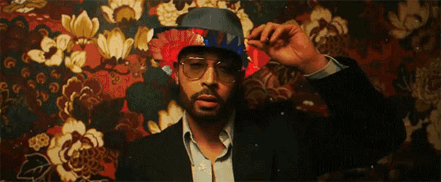 a man with a beard wearing a hat and sunglasses