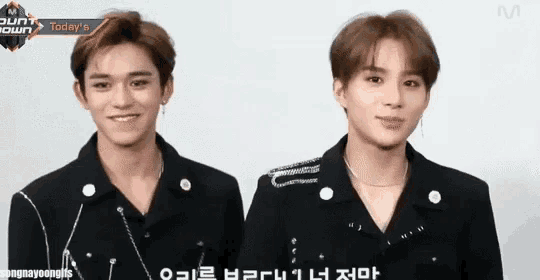 two young men are standing next to each other in front of a screen that says today 's m count down