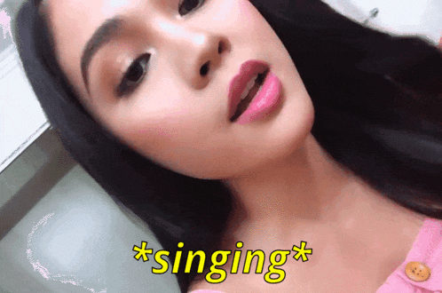 a close up of a woman 's face with the word singing in yellow letters