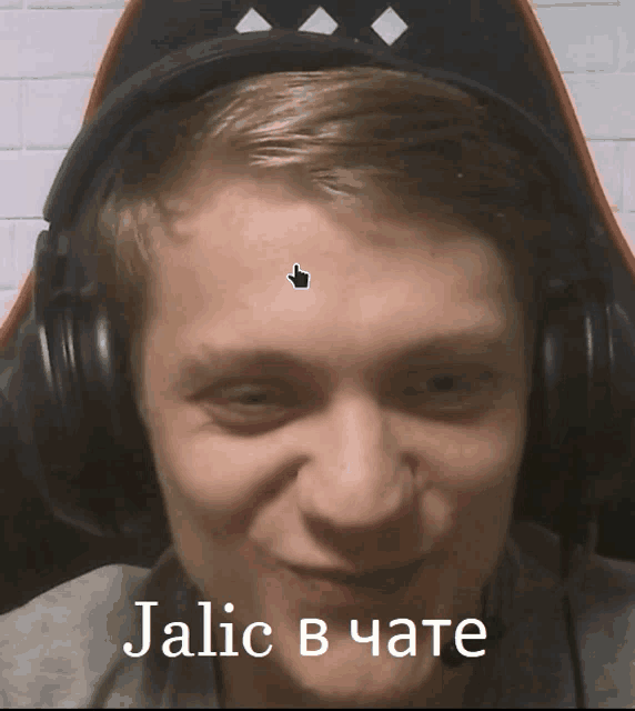 a man wearing headphones has a sticker on his forehead that says jalic