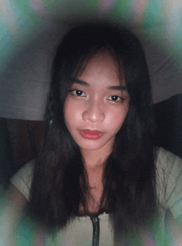 a young woman with long black hair and red lips looks at the camera