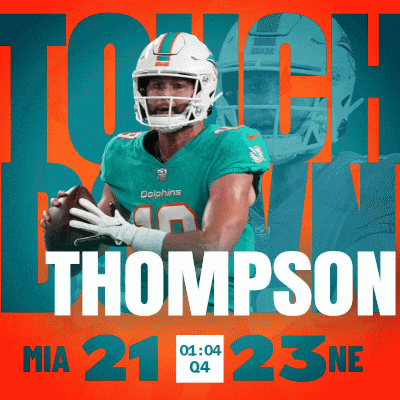 a dolphins football player named thompson is holding a ball