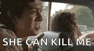 a man is sitting in the back seat of a car with a woman .