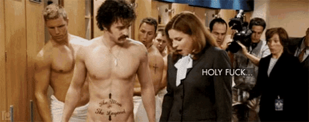 a shirtless man with a tattoo on his stomach stands in front of a group of people and a woman says holy fuck