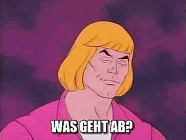 he man from the masters of the universe is making a funny face while wearing a pink shirt .