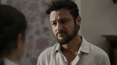 a man with a beard looks at a woman
