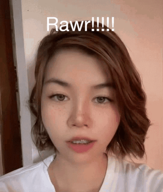 a close up of a woman 's face with the words rawr written above her