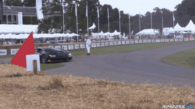 a race car is on a track with a sign that says vodafone in the background