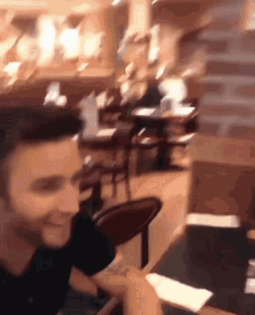 a man is sitting at a table in a restaurant