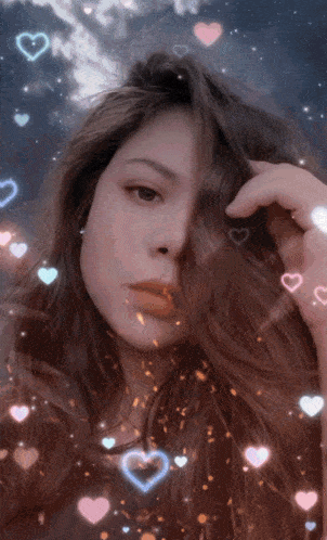 a woman 's face is surrounded by hearts and glitter