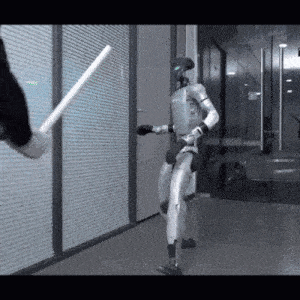 a robot is standing in a hallway with a person holding a stick in front of it