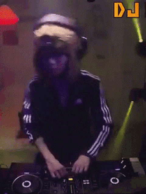 a dj wearing a wig and headphones playing music