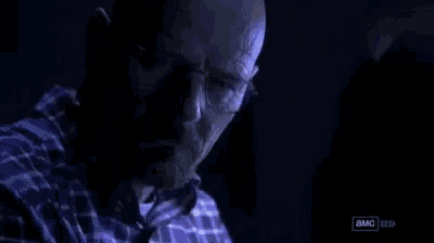 a man with glasses says you got me in a dark room