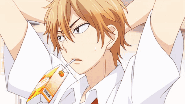 a boy is drinking orange juice through a straw from a carton