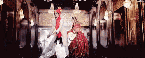 a bride and groom are dancing together in a room with a lot of lights .