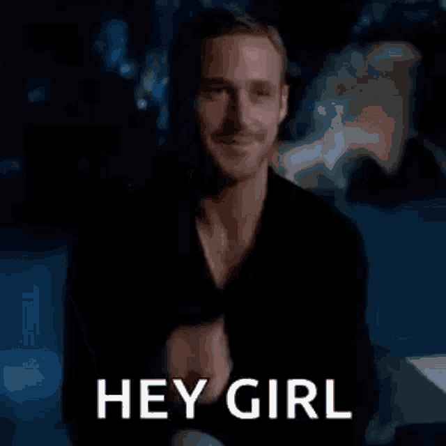 a man is sitting in a dark room with his hand on his chin and the words `` hey girl '' written on the screen .