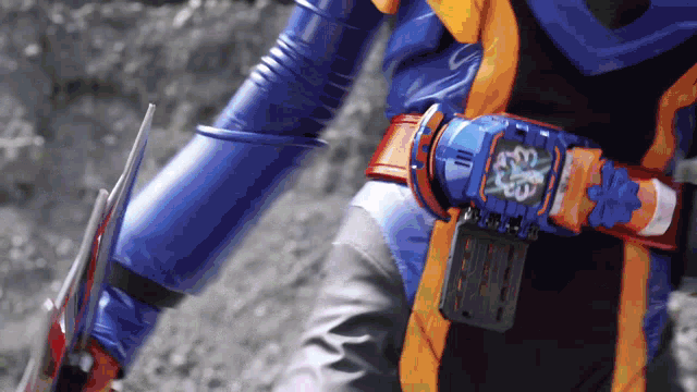 a person wearing a blue and orange costume with a watch on their waist
