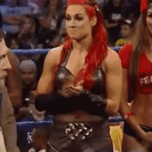 a woman with red hair is standing in a ring .