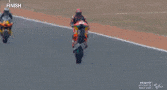 a man is riding a motorcycle with the number 53 on the back