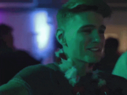 a young man wearing a lei around his neck