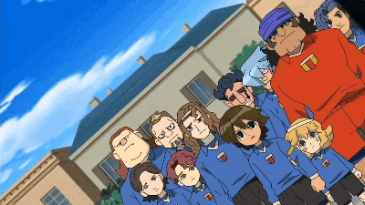 a group of people are posing for a picture and one of them has the letter t on their shirt