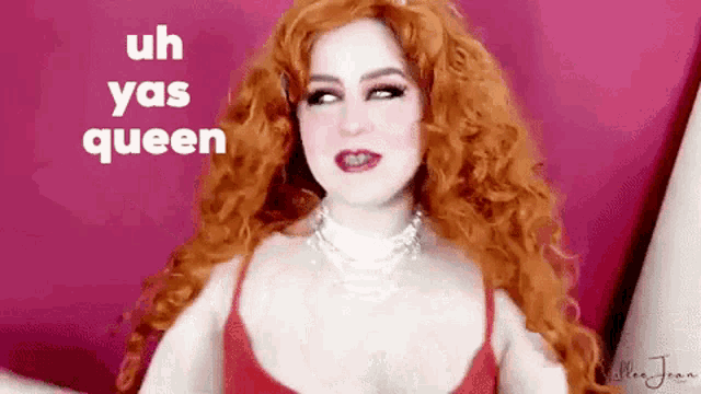 a woman with red hair is wearing a red bra and a necklace .