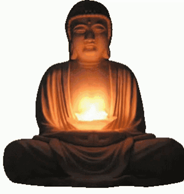 a statue of a buddha with a lit candle in front of it