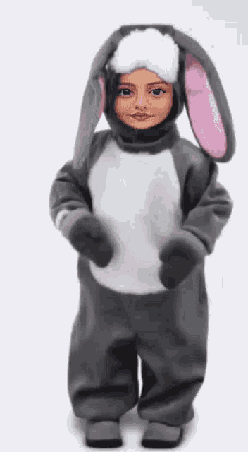 a child is dressed in a bunny costume and has a face on it