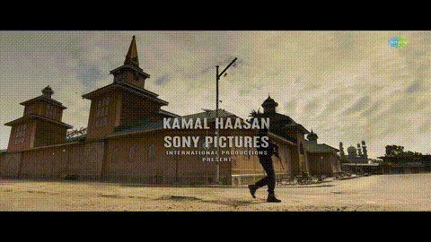 a man is walking in front of a building that says kamal haasan sony pictures