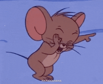 jerry from tom and jerry is laughing and pointing at the camera .