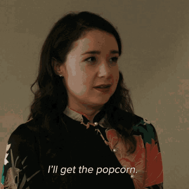a woman says " i 'll get the popcorn " in front of her face
