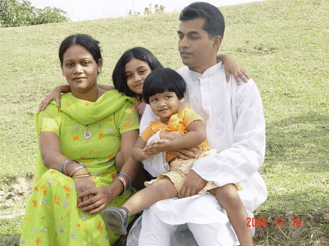 a family posing for a picture with a date of 2004